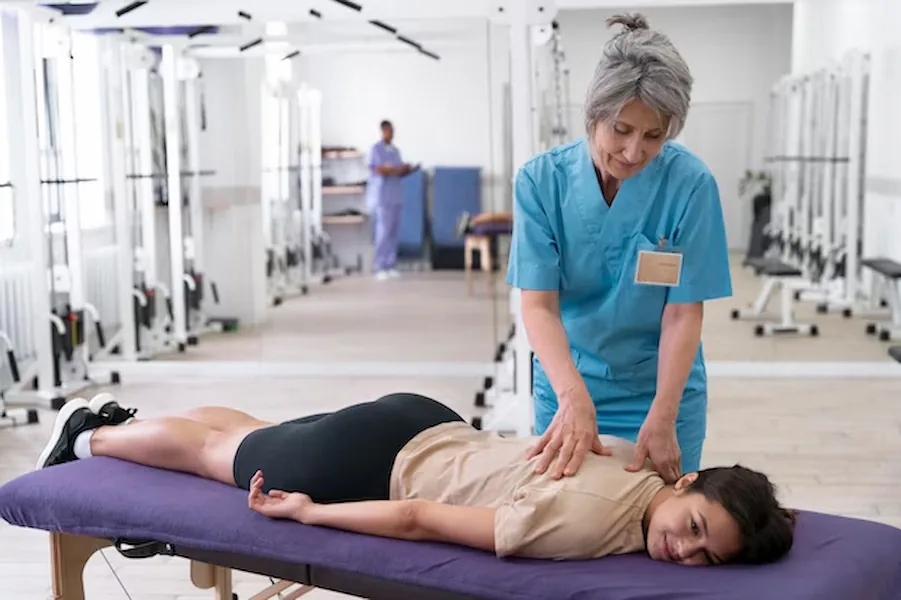 Physiotherapist treating a patient’s back